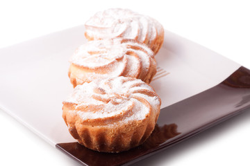 Three fresh muffins on plate isolated