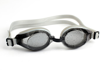 goggles for diving  in water droplets on white background