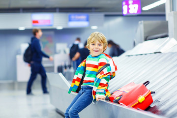 little tired kid boy at the airport, traveling