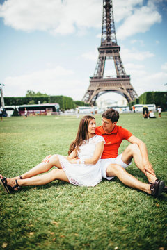couple of tourists taking photo with Eiffel Tower in Paris,  tourism in Europe, France