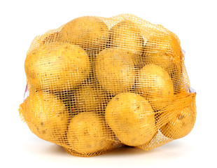 Heap of yellow raw potatos in red string bag