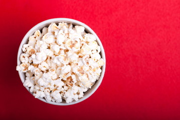 box of popcorn on a red background, top view