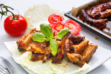 Grilled pork ribs served on a platter. Step on step recipe.