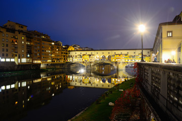 Ponte Vecchio under a clear sky by night