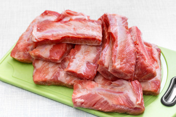 Raw pork ribs on a cutting board. Step on step recipe.