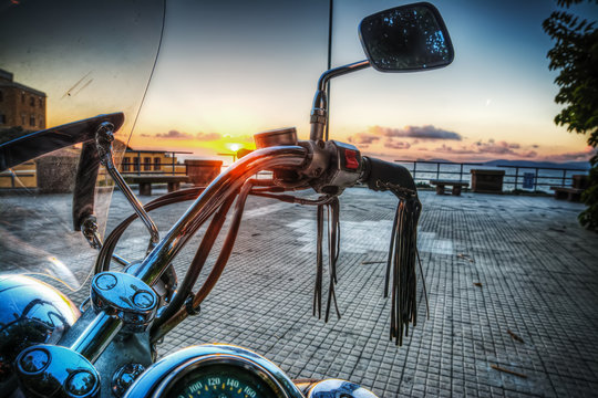 classic motorcycle by the sea at sunset
