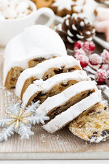 Christmas Stollen on wooden board and cookies, closeup vertical