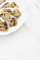 Christmas Stollen with marzipan and white wooden background 