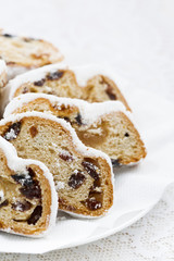 Christmas Stollen with marzipan on a plate, vertical