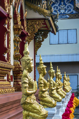 several statues of meditating Buddhas in the temples of Thailand