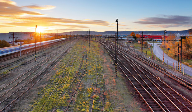 Railroad with train - Railway at sunset with sun