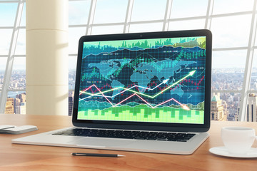 Business chart on laptop screen with pen, diary and coffee mug o