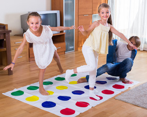 Children playing twister at home.
