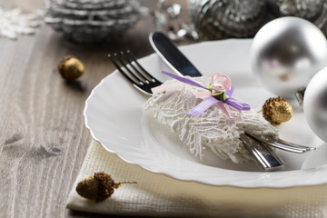 Fototapeta na wymiar Christmas dinner table. Traditional Christmas decorations. Romantic table setting.