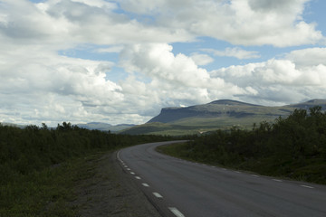 A curved road in the Swedish mountains above the arctic circle