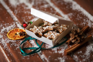 Christmas cookies. Gingerbread cookies in the box over wooden ba