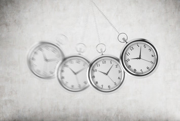 A pocket watch as a swing of the pendulum. Concrete background. 3D rendering. Time is money concept. © ImageFlow