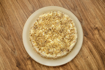 Delicious tart on the plate on a wooden background