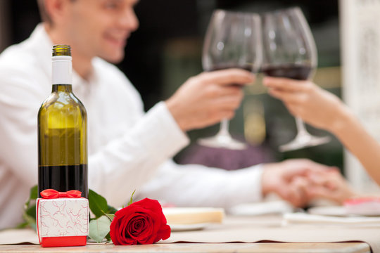 Cheerful loving couple is celebrating in cafe