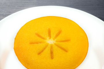 Persimmon cut on a plate