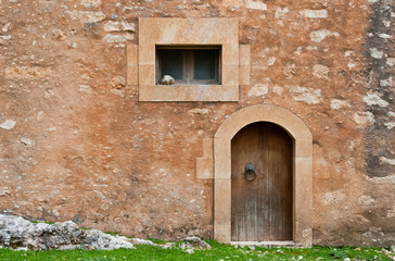 Details of a stone wall with window and door