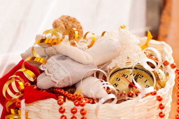 Fototapeta na wymiar basket with Christmas toys and clock hands for 12 hours