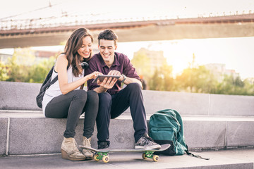 Couple using tablet outdoors