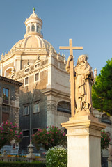 Statue of Virgin Mary in Catania with a church in the background