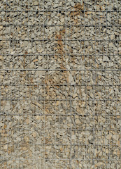 Gabion retaining wall - grey stones in gabion baskets kept by retaining wall wire mesh