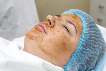 woman passes treatment mask facial at the beauty salon