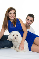 Happy Young couple with a white dog - first baby