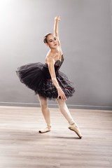  Ballerina is wearing a white tutu and pointe shoes © V&P Photo Studio
