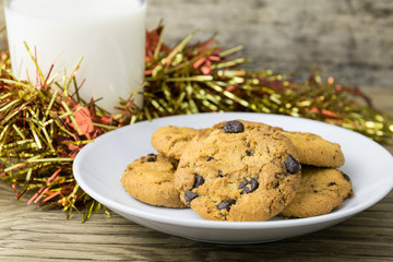 cookies and a glass with milk on wooden table