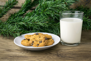 cookies and a glass with milk with a white note for santa