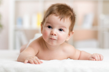 Portrait of cute 3 months baby lying down on blanket