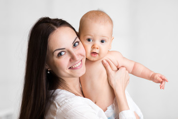 Portrait of cute little boy with mother, baby with mommy, pretty woman and child have a fun