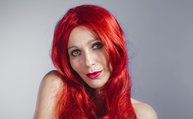 Spanish woman with long red hair, nude color and long black late