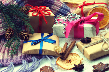 Christmas gift boxes, fir tree branch, winter scarf and dried fruits