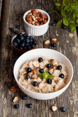 Bowl of oatmeal porridge with blueberry and mint