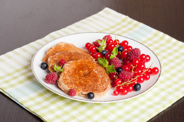 sweet cheese pancakes with fresh berries and milk