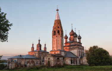 Fototapeta na wymiar Russia, the village Parsky. The ensemble of the Church of the Beheading of St. John the Baptist and Ascension at sunset