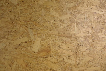 Panel from compressed wood chips and resin