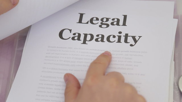 Doctor Holding Legal capacity lawsuit papers