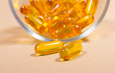 Omega 3 capsules from fish oil on pastel background.
