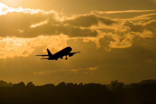 Fototapeta Silhouette plane take off in morning