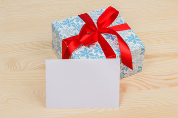 Gift in a beautiful package with a red ribbon