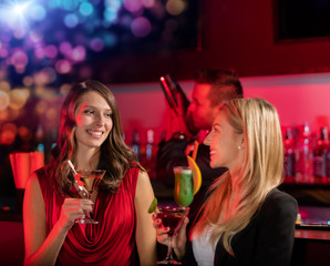 Two girls at the bar with cocktail drink