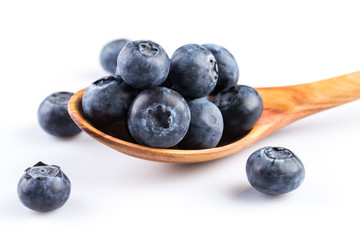 Fresh blueberries in wooden spoon