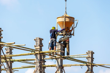 Worker working in construction on blue sky