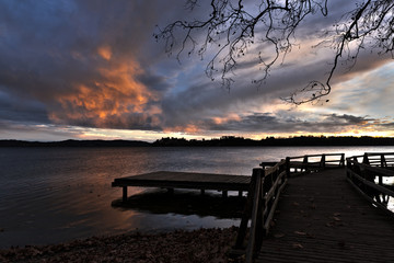 Naklejka na ściany i meble Sunset on the Varese lake with cloudy sky over the lake